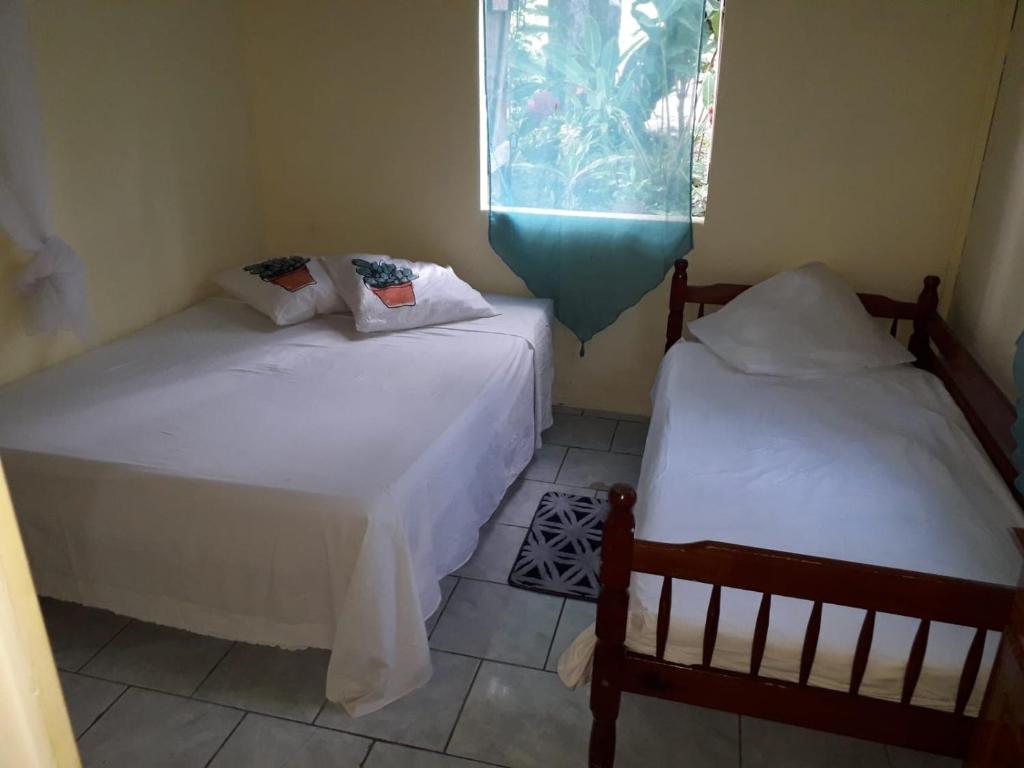 2 camas en una habitación pequeña con ventana en Maison de la plage, en Trois-Rivières