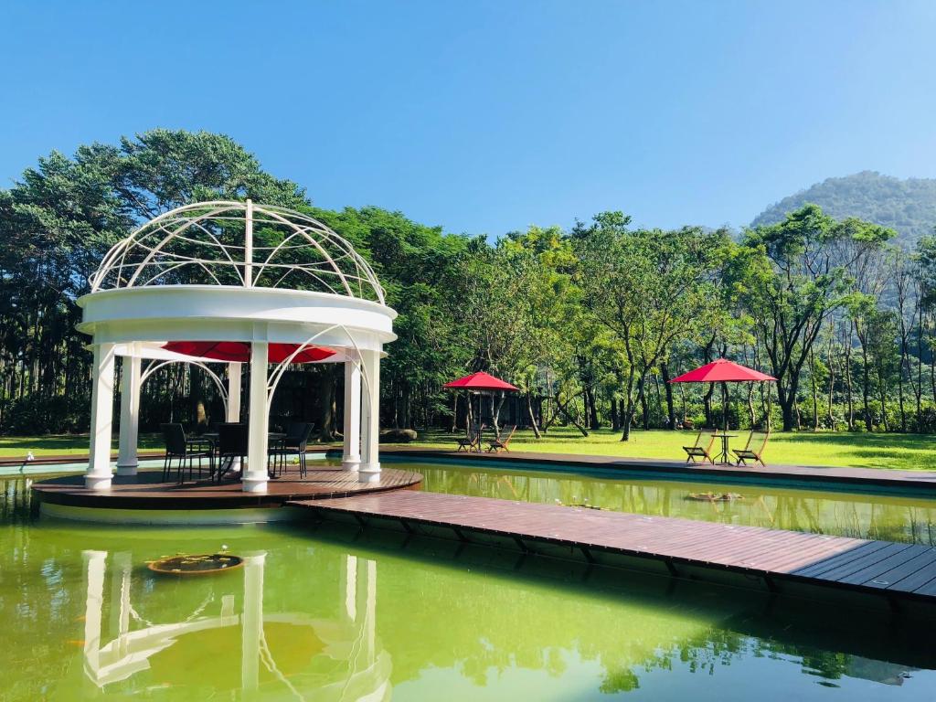 a pavilion in the middle of a pond in a park at 藏青谷 莊園Valley Statt Manor in Liugui