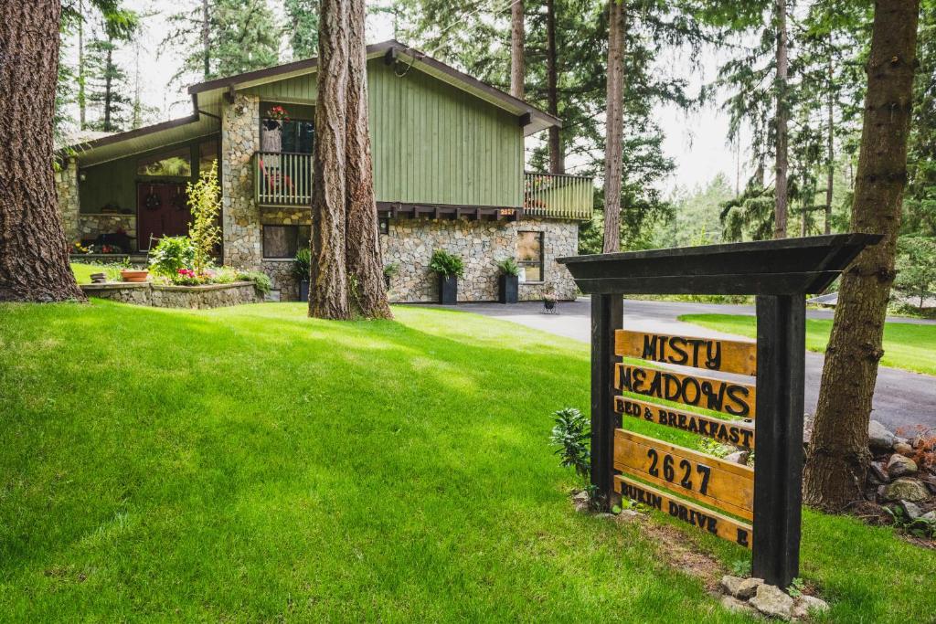 a house with a sign in front of a yard at Misty Meadows B&B in Langford