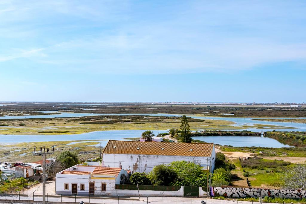 an aerial view of a building next to a river at The Nest Apartment - Sea View - Faro in Faro