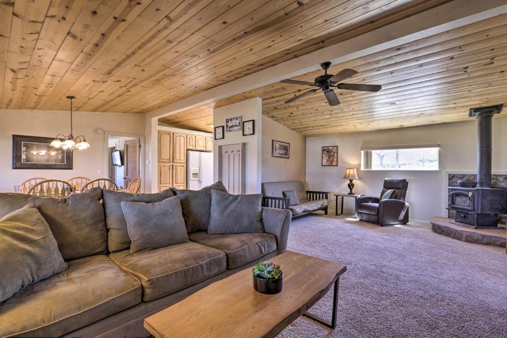 a living room with a couch and a wood ceiling at Rustic Bullhead City Retreat with Porch and Views in Bullhead City