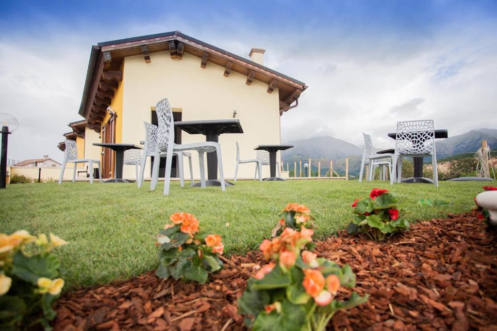 a group of chairs and tables on a yard with a house at Albergo Diffuso Amatrice in Amatrice