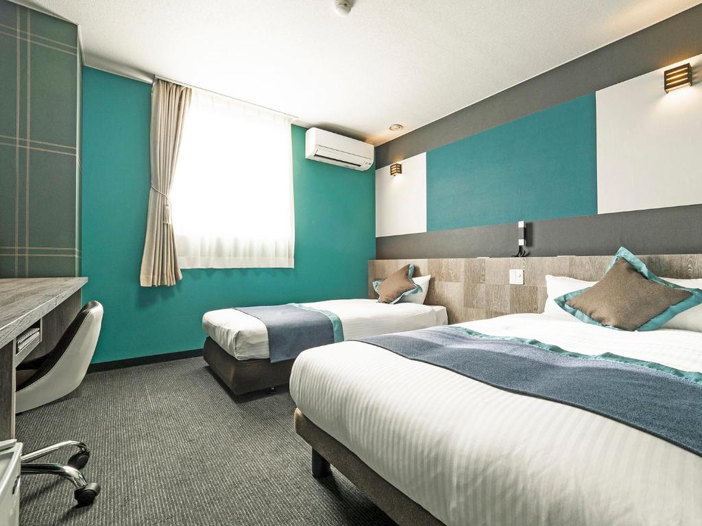 Postel nebo postele na pokoji v ubytování Hotel Areaone Tokai