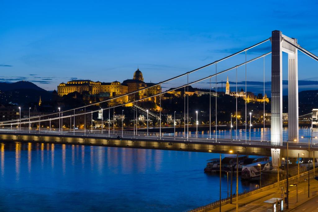 a bridge over water with a city in the background at Hotel Vision Budapest by Continental Group in Budapest