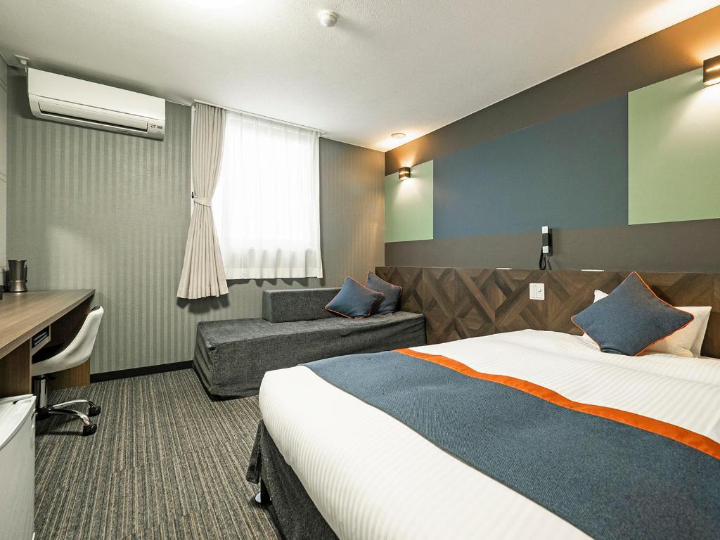 Postel nebo postele na pokoji v ubytování Hotel Areaone Tokai