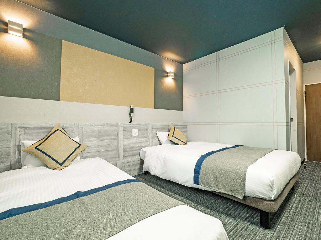 Postel nebo postele na pokoji v ubytování Hotel Areaone Tokai