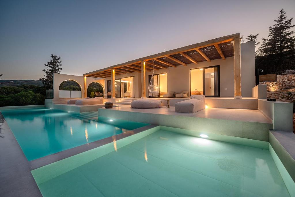 a house with a swimming pool in front of it at URANOS di GIOIA Villa with magnificent sea view and infinity pool 18x4m in Zakynthos
