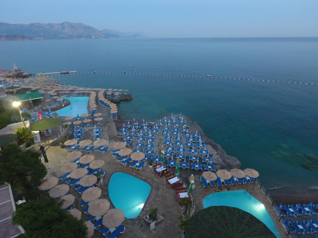 an aerial view of a resort with a pool and the ocean at Trsteno Beach Apartments in Budva