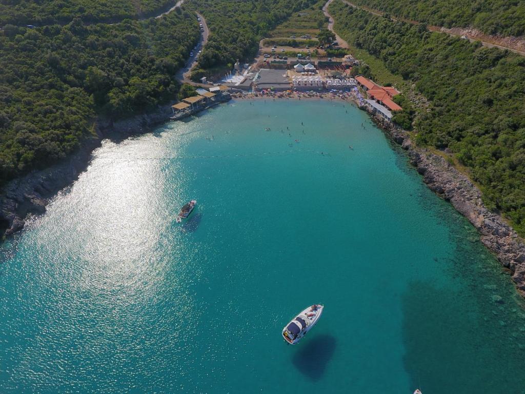 two boats in a large body of water at Trsteno Beach Apartments in Budva
