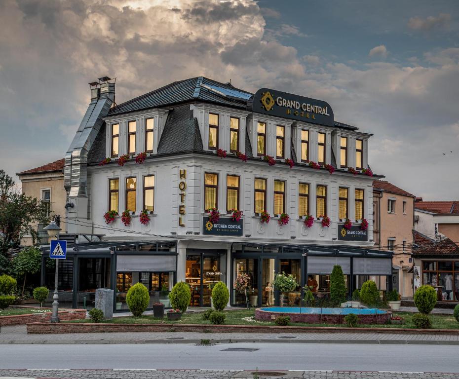 a large white building with a sign on it at Grand Central Hotel in Bitola