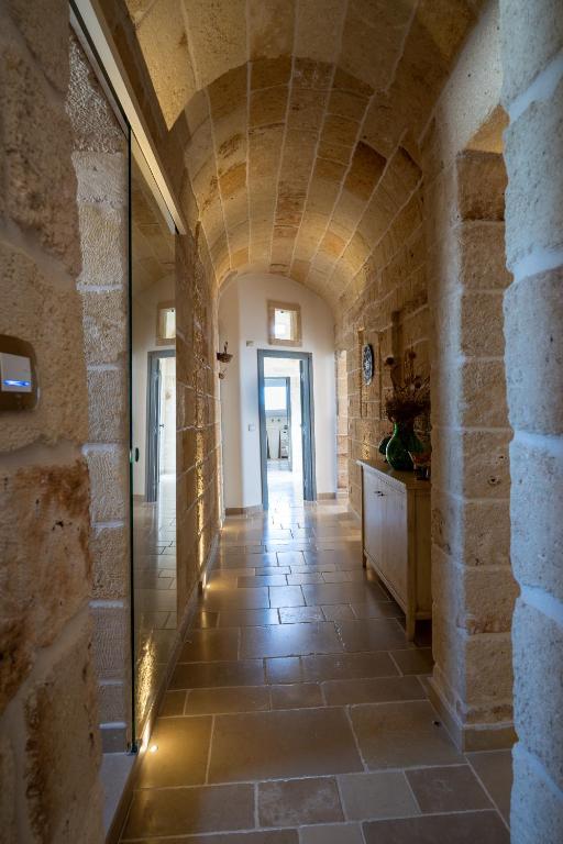 a hallway of a house with a stone wall at Corte Fantasia in Triggianello