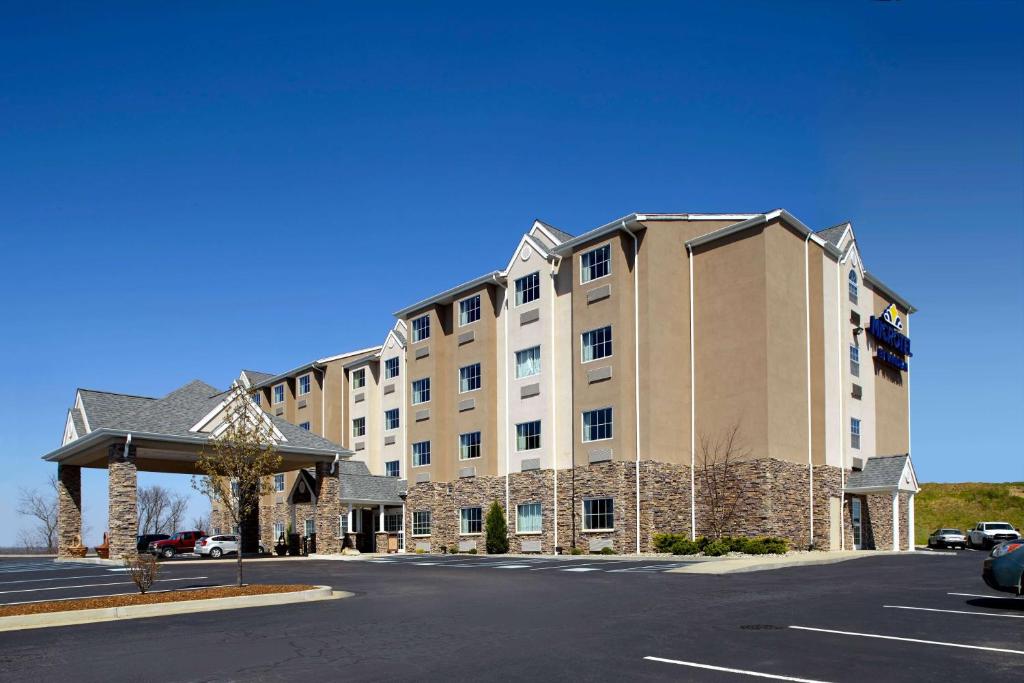 a large building on a street with a parking lot at Microtel Inn & Suites by Wyndham New Martinsville in New Martinsville