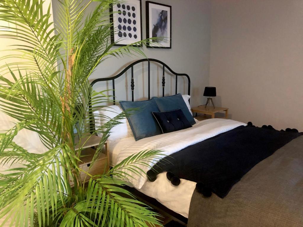 a bedroom with a bed and a palm tree at Angel Suites in Nicosia