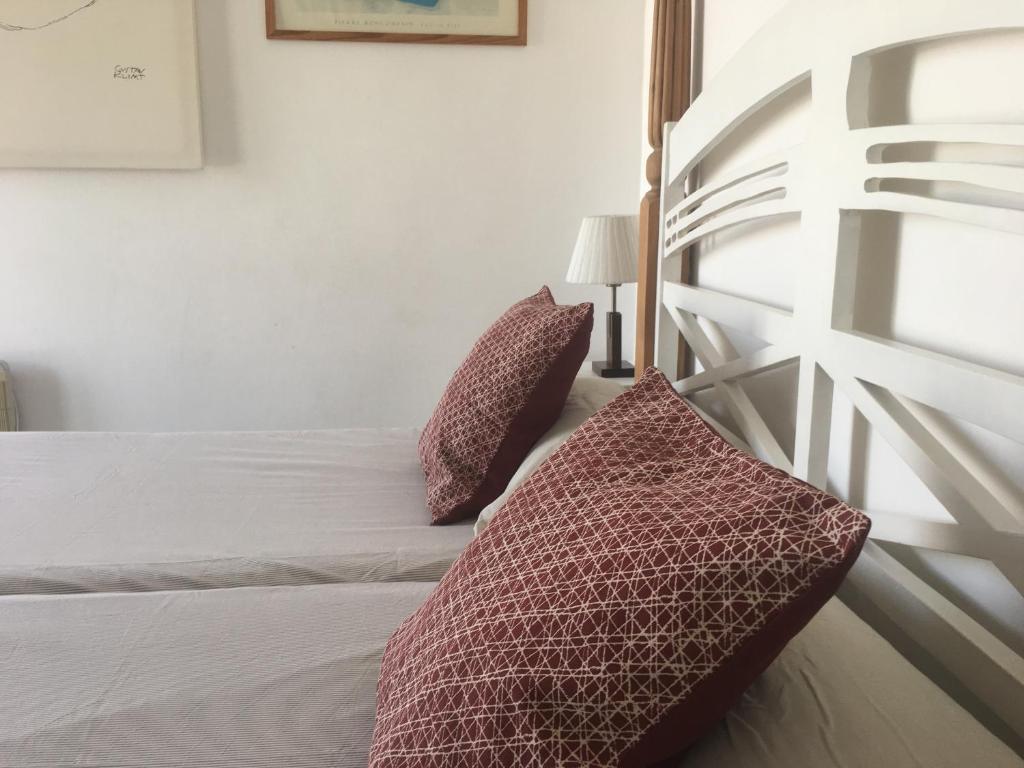 a bedroom with a bed with two pillows on it at Barceloneta Ramblas Apartments in Barcelona