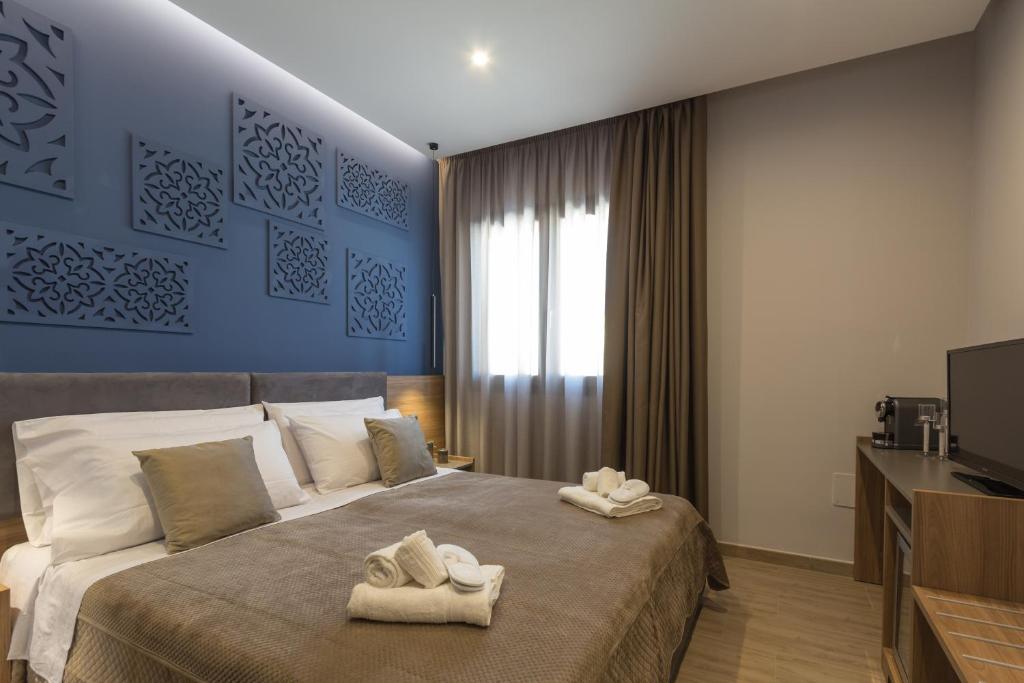 a bedroom with a bed with towels on it at Giafra Luxury Rooms in Agrigento