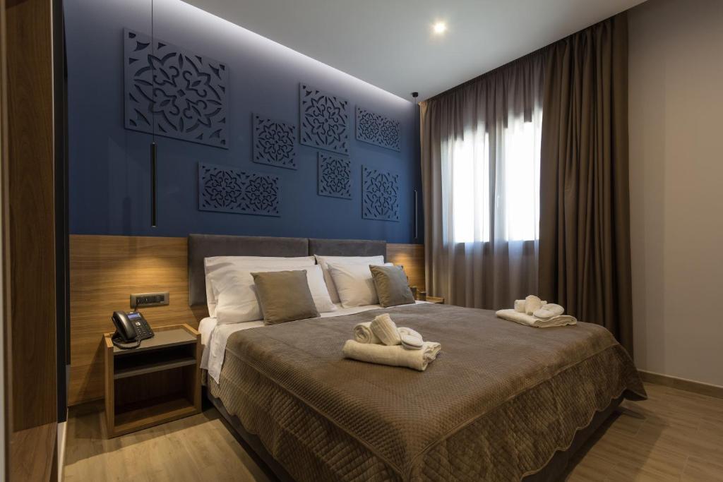 a bedroom with a large bed with towels on it at Giafra Luxury Rooms in Agrigento