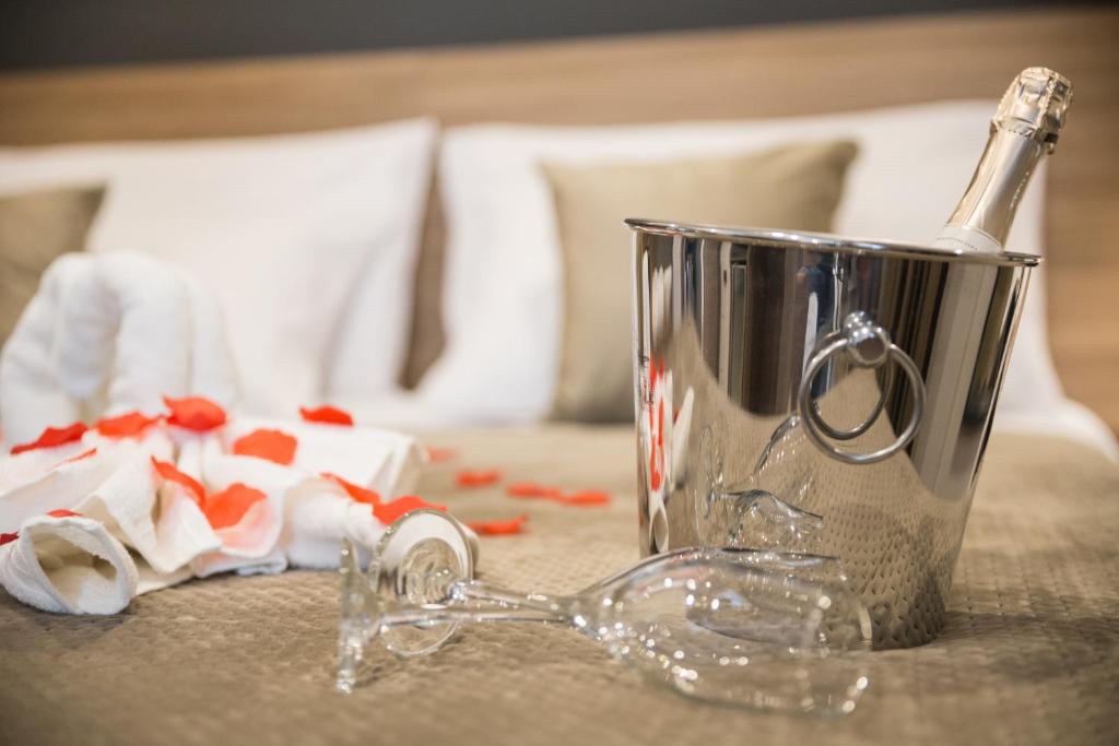 a glass mug with a bottle of champagne on a table at Giafra Luxury Rooms in Agrigento