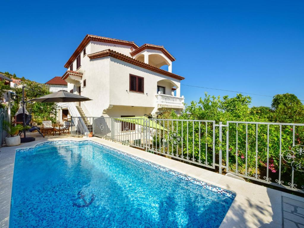 a villa with a swimming pool in front of a house at Apartment Antoine by Interhome in Marina