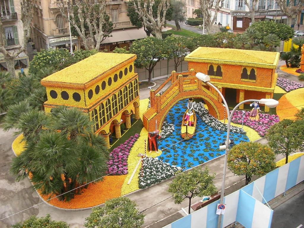 an aerial view of a water park in a city at Hotel Chambord in Menton