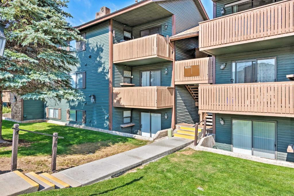 an apartment building with balconies and a yard at Park City Condo with View - Walk to ShopsandDining in Park City