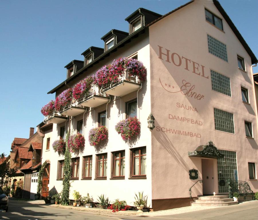 a hotel with flowers on the side of a building at Hotel Ebner in Bad Königshofen im Grabfeld