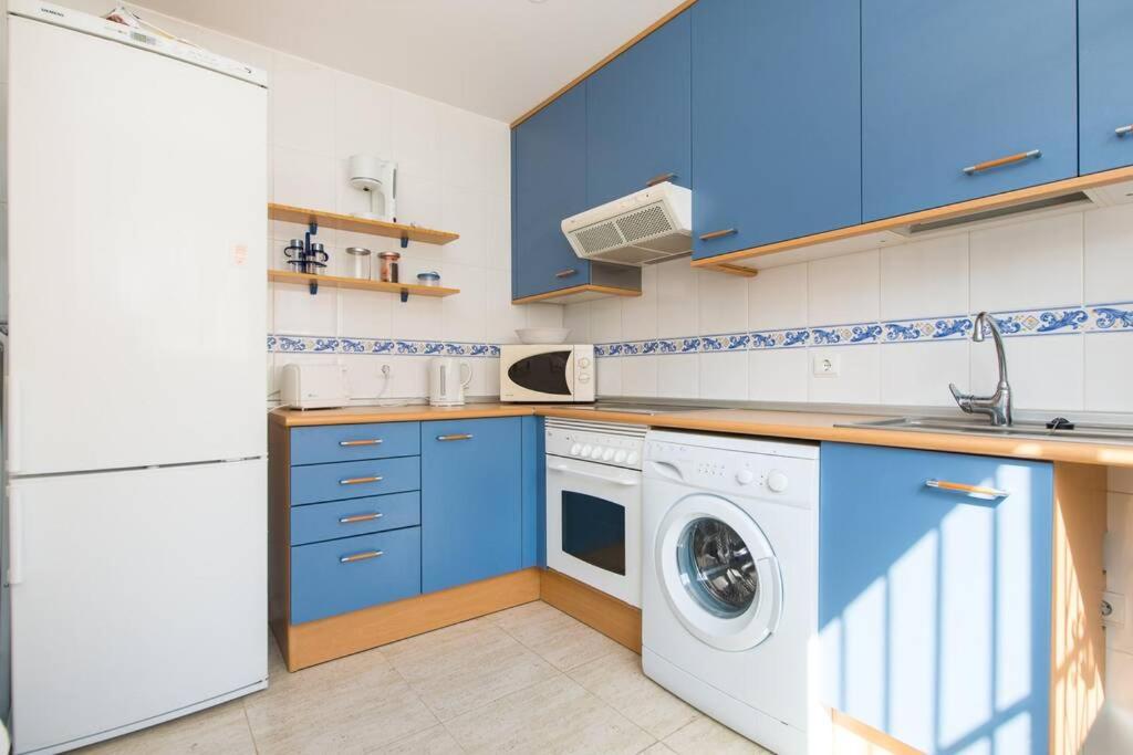 A kitchen or kitchenette at Happy Holiday Home! 2 pools - Walk to Town & Beach