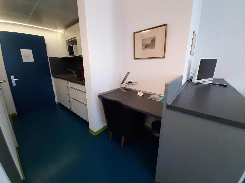 an office with a desk with a computer on it at Domus Hotel in Luxembourg