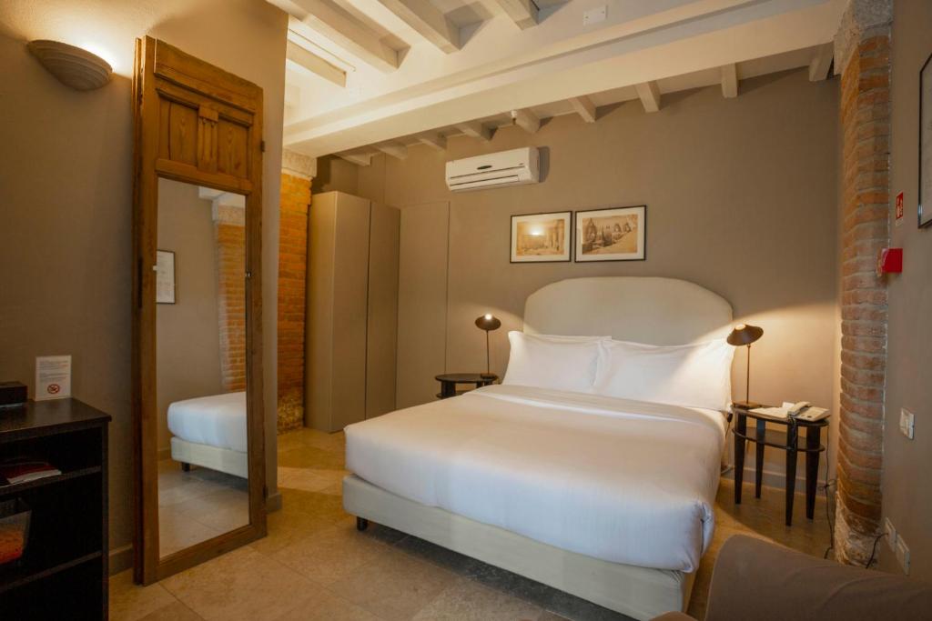 Postel nebo postele na pokoji v ubytování Santellone Resort
