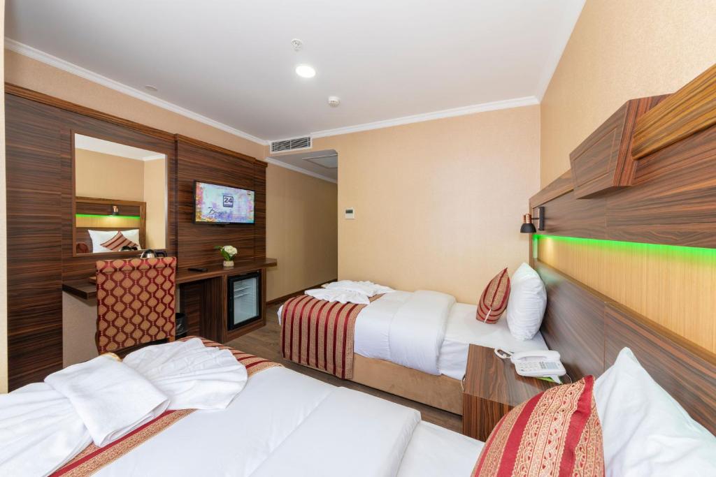 Postel nebo postele na pokoji v ubytování Vision Deluxe Hotel