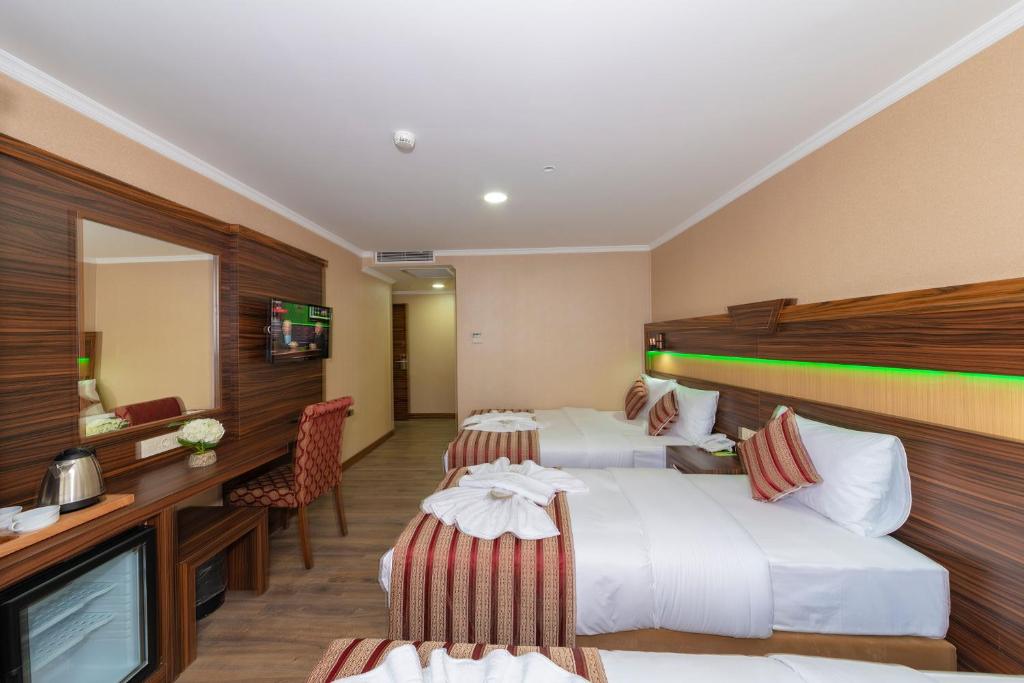 Postel nebo postele na pokoji v ubytování Vision Deluxe Hotel