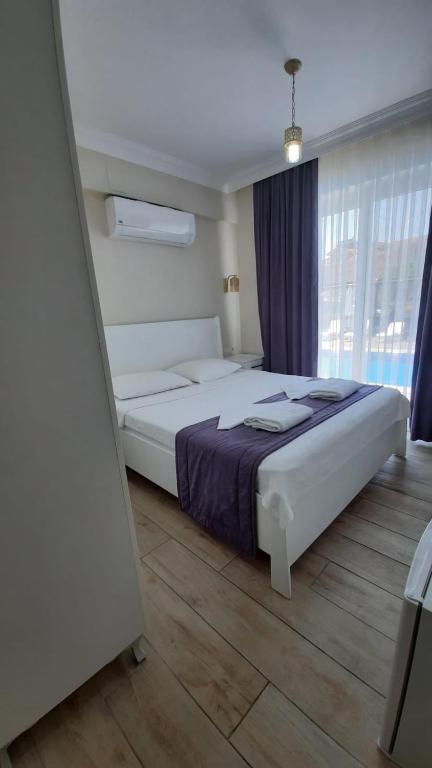 Postel nebo postele na pokoji v ubytování Vespera hotel