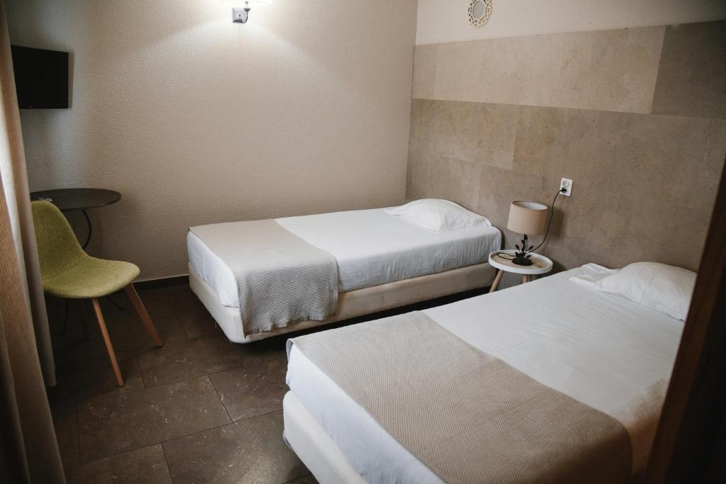 Кровать или кровати в номере Hotel Laitau