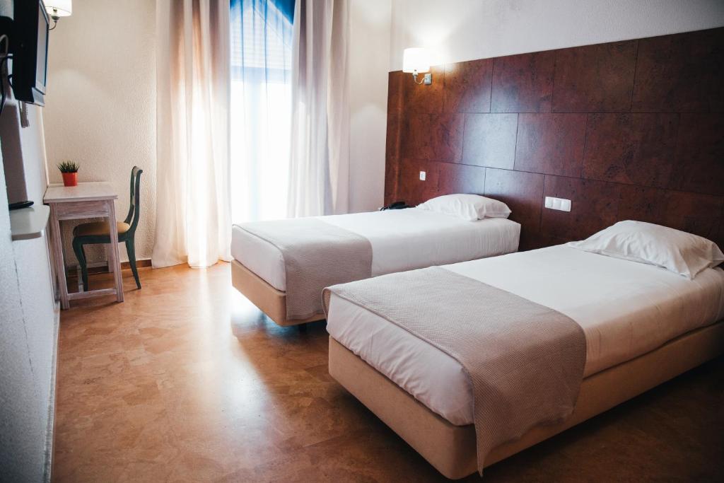 Кровать или кровати в номере Hotel Laitau