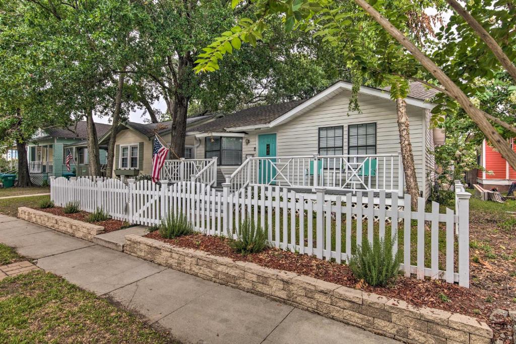 a white picket fence in front of a house at Gulfport Bungalow by Jones Park and Beach Access! in Gulfport