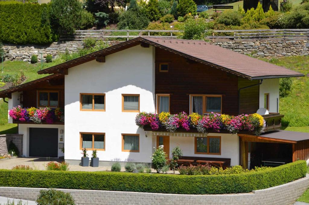 a house with flower boxes on the front of it at Ferienwohnung Plattner inklusive Sommercard in Jerzens