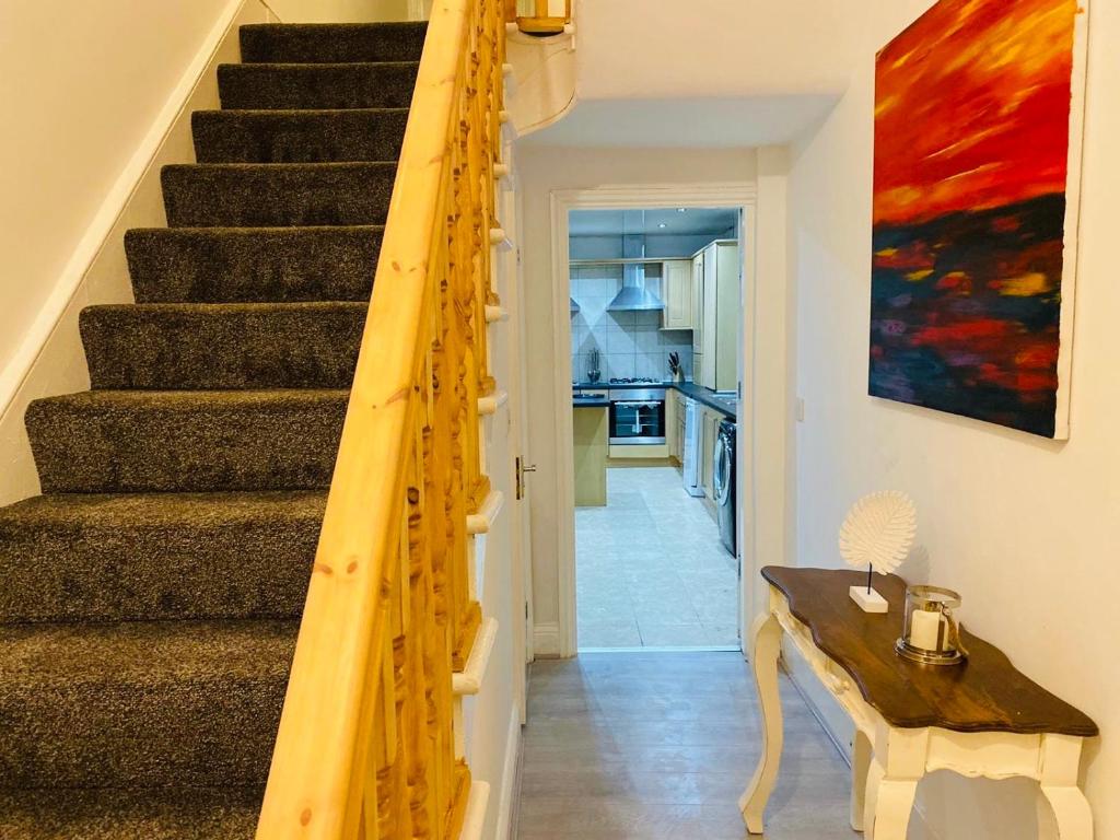 a staircase in a house with a wooden railing at Callerton House in Newcastle upon Tyne