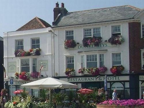 a large white building with flowers in front of it at Dunkerley's Hotel and Restaurant in Deal