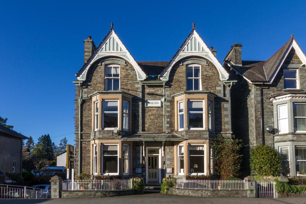 a large brown brick house with white windows at Elder Grove in Ambleside