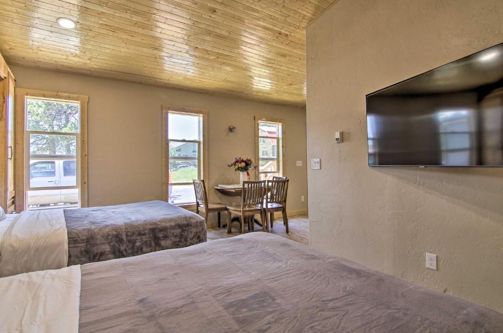 1 Schlafzimmer mit 2 Betten und einem Flachbild-TV in der Unterkunft Mountain Cabin, Walk to Dining and Memorial Park! in Woodland Park