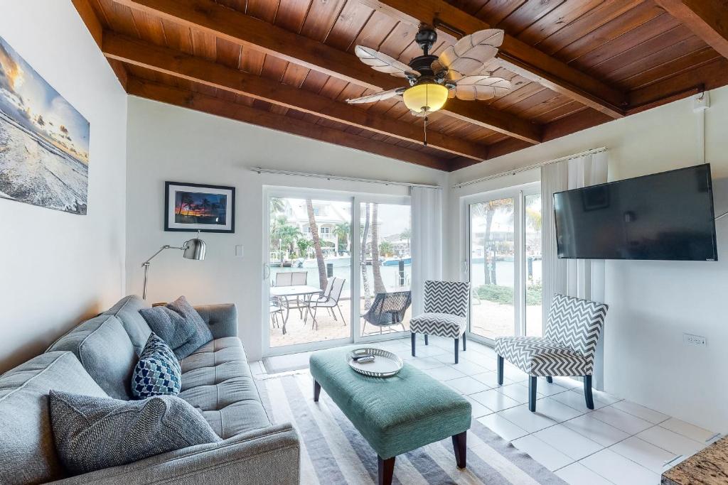 a living room with a couch and a ceiling fan at R & R Retreat in Key Colony Beach