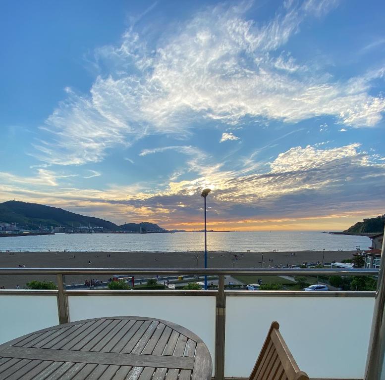 a balcony with a view of the beach and the ocean at Petit Palace Tamarises in Getxo