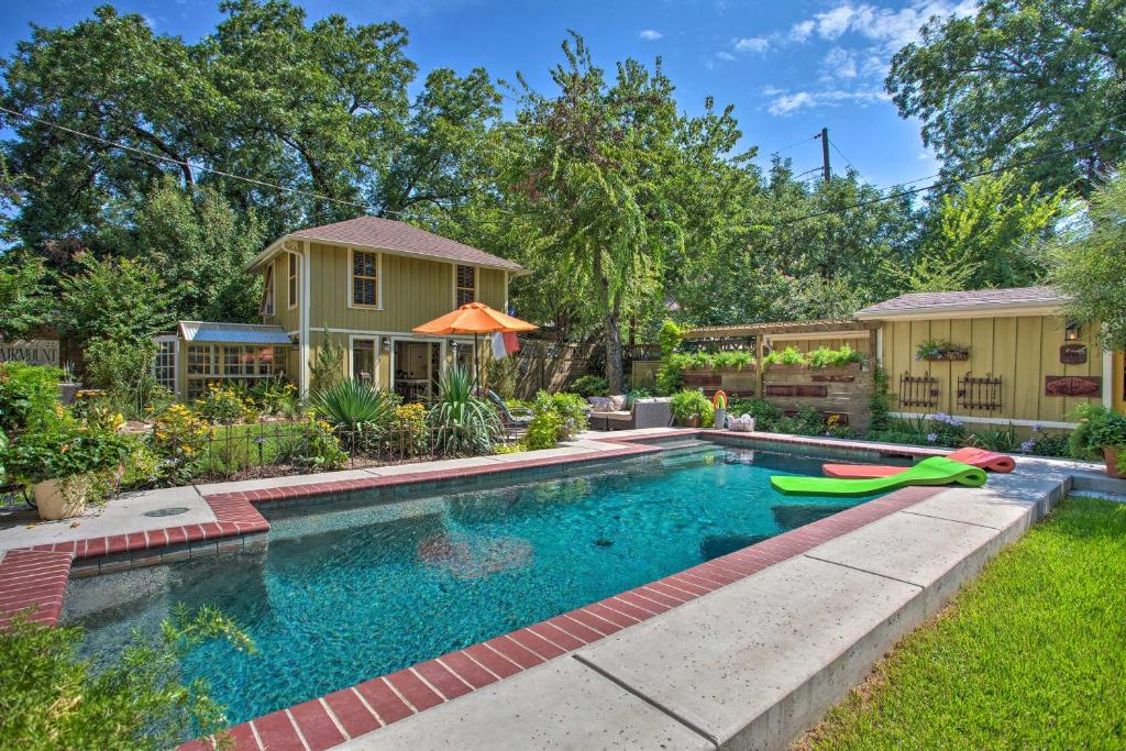 a swimming pool in a yard with a house at 4 Mi to Dtwn! Fort Worth Cottage w/ Shared Pool in Fort Worth