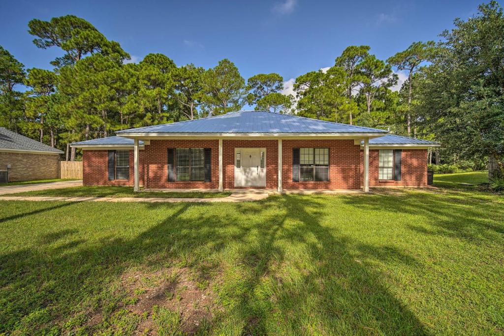 a red brick house with a large yard at Updated Gulf Coast Home with Yard Near the Beach! in Dauphin Island
