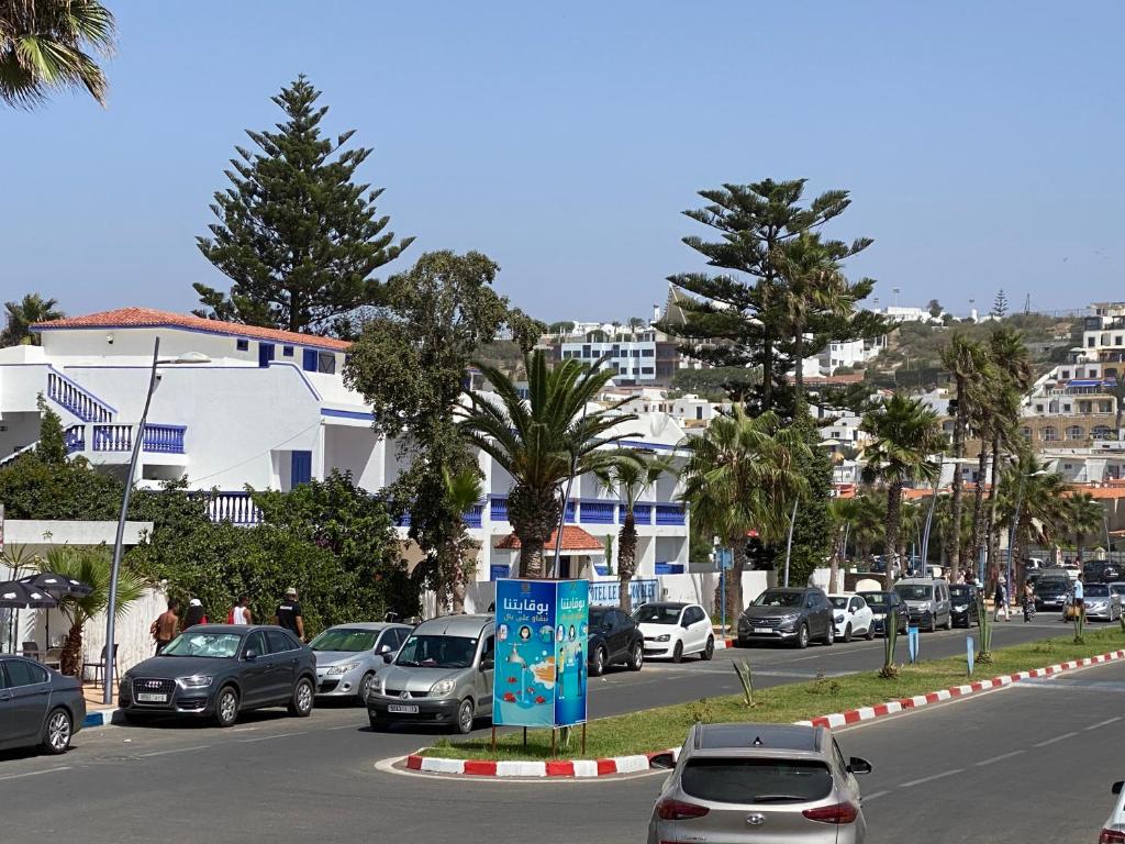 a street with cars parked on the side of the road at Le Lagon Bleu Oualidia in Oualidia
