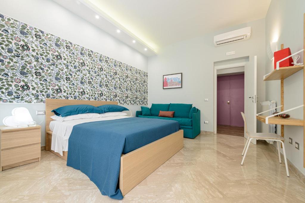 a bedroom with a blue bed and a blue couch at Dimora San Gennaro 10 in Naples
