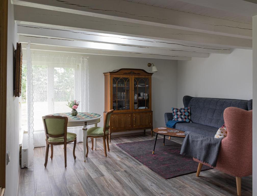 a living room with a couch and a table at Namelis prie Širvintos upės su pirtimi in Širvintos