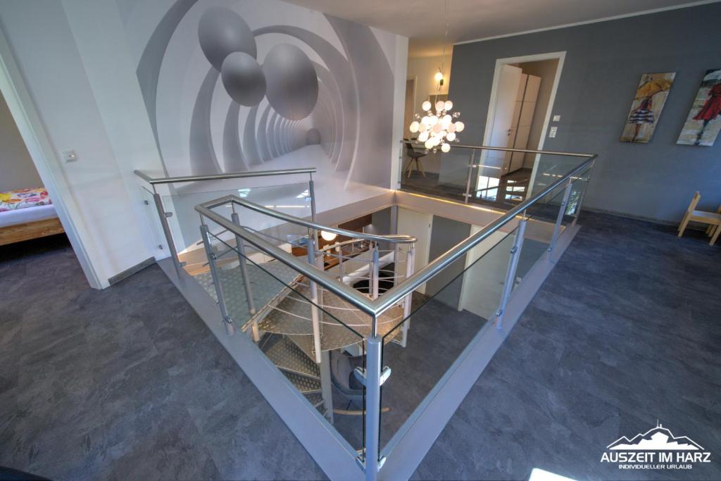 a room with a staircase with a glass case at Ferienloft am Steinweg in Elbingerode