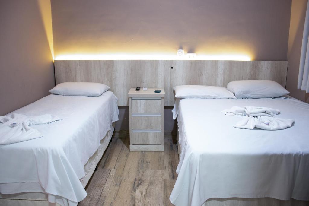 Cama ou camas em um quarto em Hotel Ipiranga Maringa