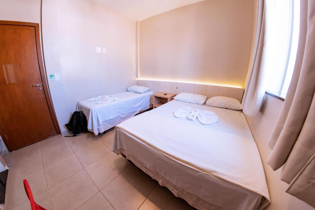 Postel nebo postele na pokoji v ubytování Hotel Ipiranga Maringa