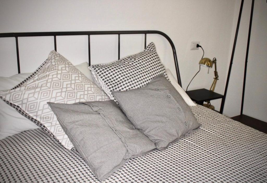 a bed with several pillows on top of it at bedandclimbing in Baunei